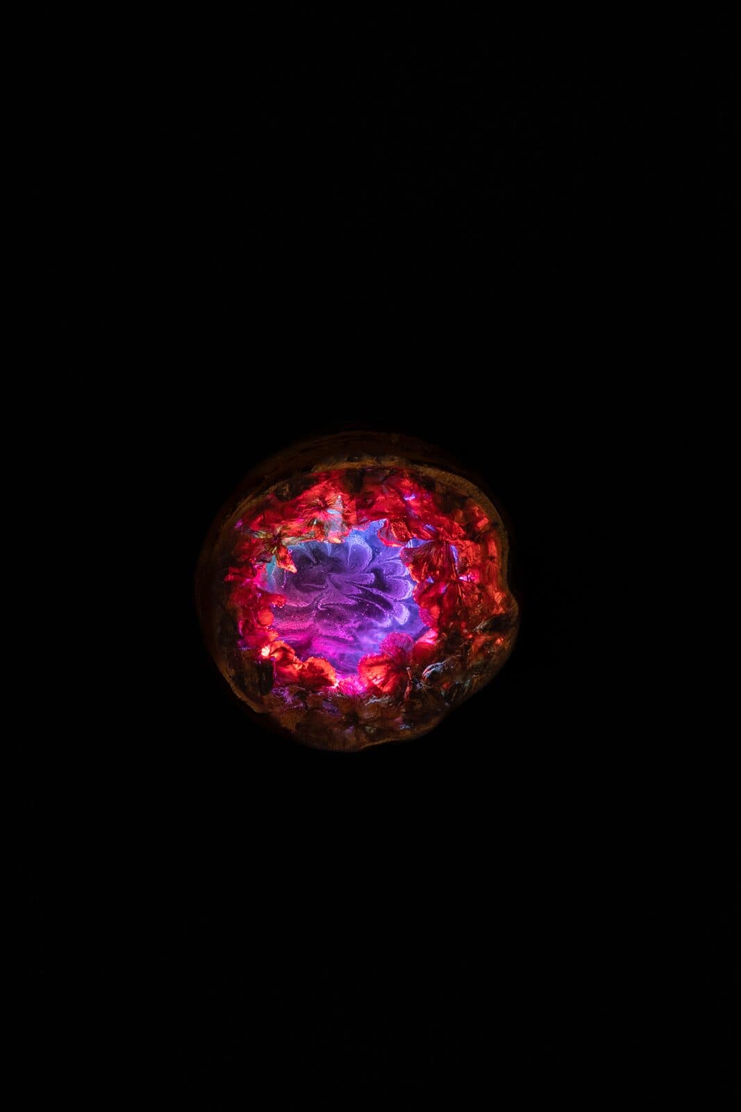 An Eluztres lamp glowing on black